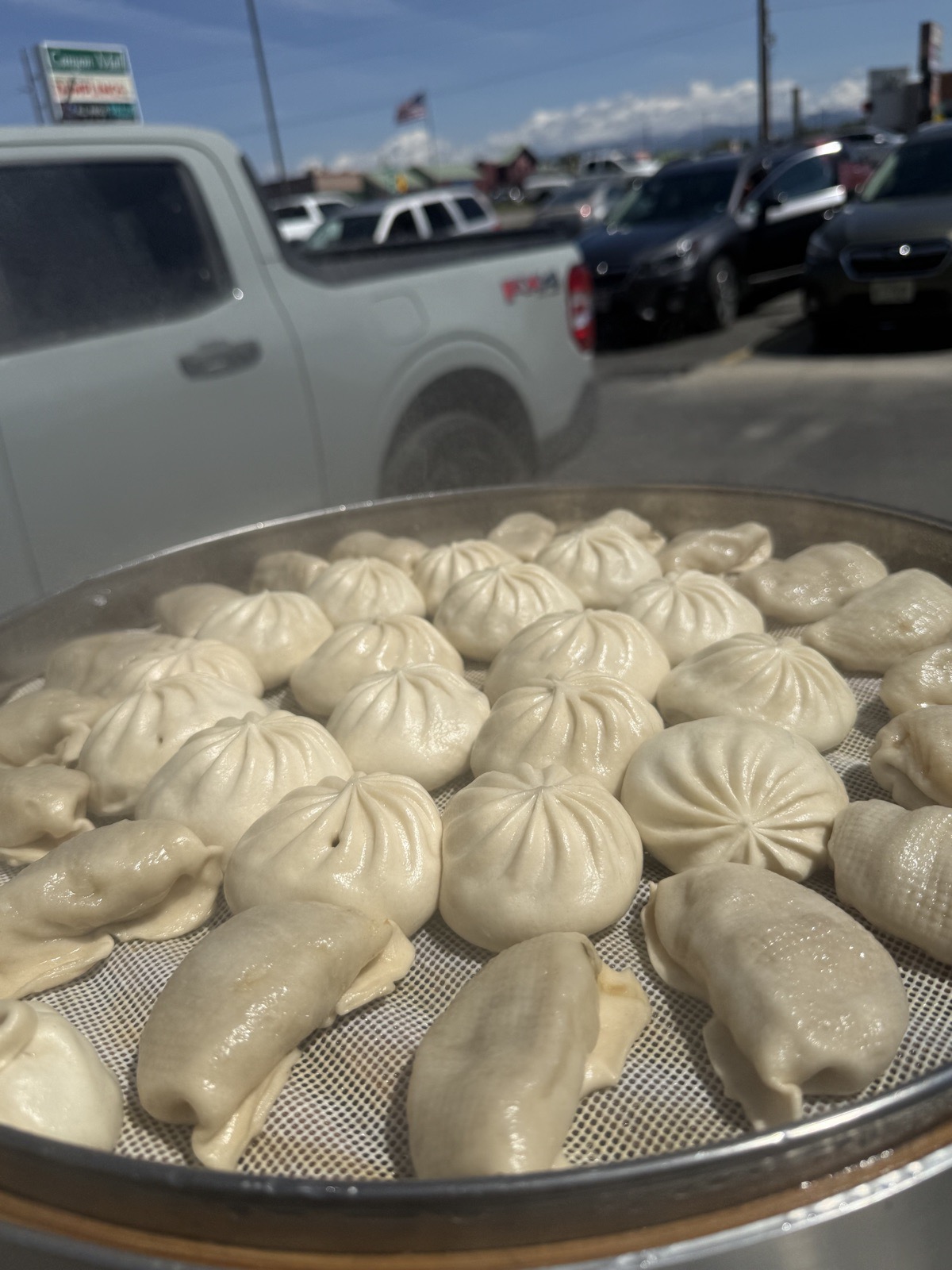 A tray of freshly steamed bao buns, golden and ready to serve